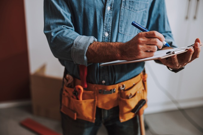 Man writing on clipboard